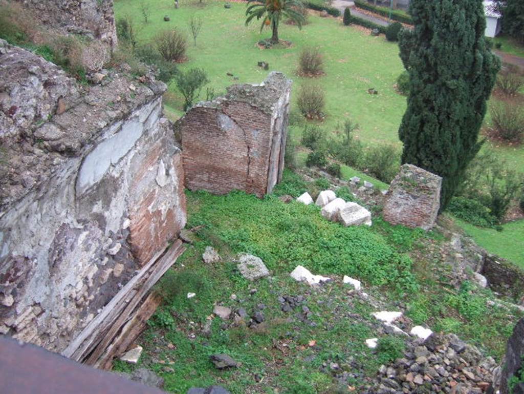 VIII.2.1 Pompeii. December 2005.
Looking from south portico to lower floors which would have been under the terrace.
According to PPM –
This photo is looking down onto the large triclinium (called “J”) which would have had a panoramic view to the south, the east wall is on the left.
According to PPM –
This would have had walls painted in the IV Style with a decorative scheme with partitions, not reconstructable as the plaster had fallen:
the white background was also taken up into the vault, where some traces of squares with large rectangles remain.
See Carratelli, G. P., 1990-2003. Pompei: Pitture e Mosaici. VIII (8) Roma: Istituto della enciclopedia italiana, (p.55, no.53).
Looking ahead to area of cubiculum (θ) and triclinium (η).
According to PPM –
The work of liberation of the southern slopes of the city from the product of the eruption, following immediately after the war, had brought to light other rooms probably pertinent to this house.
In room (η), the north wall had a large window (?) looking into cubiculum (θ), and was decorated in II Style.
On the west side of this room “J” (on the right), would have been another large room, (called (К) similar to large triclinium “J”), linked by a doorway.