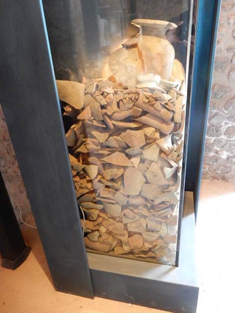 On display in Championnet complex Pompeii. May 2018. A well was rediscovered in one of the public buildings facing the Forum, and dated to the 2nd century BC, when the area was occupied by workshops.
It was filled with containers for the transport of wine and fish sauces produced in the Italian peninsula, Africa and Spain.
Photo courtesy of Buzz Ferebee.