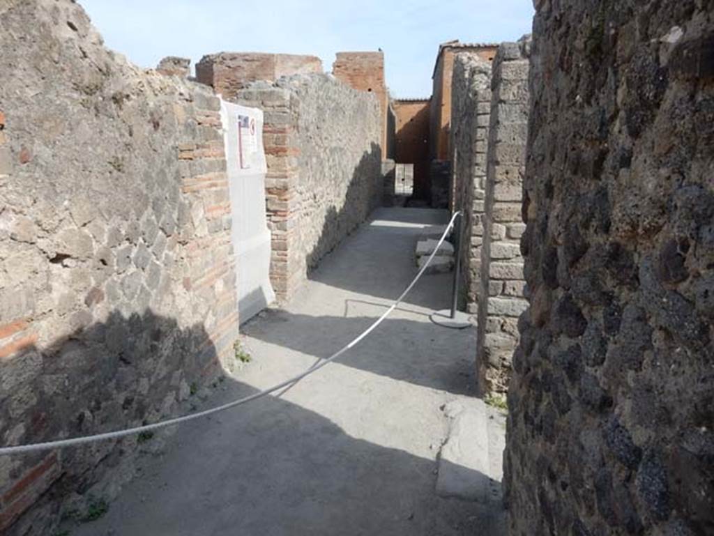 VIII.2.7/13/14/16 Pompeii. May 2017. Looking north along rear passageway leading to VIII.2.7, from near doorways of VIII.2.13/14, on right. Photo courtesy of Buzz Ferebee.