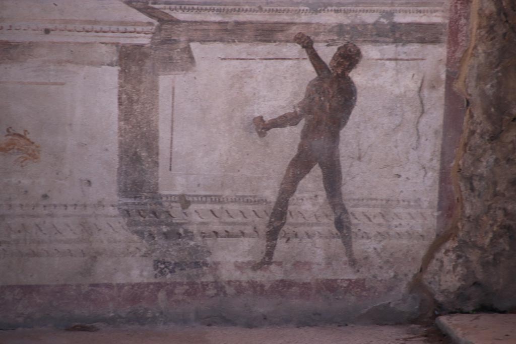 VIII.2.23 Pompeii. October 2022.
Detail of painted figure on the zoccolo/dado at the west end of the south wall. Photo courtesy of Klaus Heese.