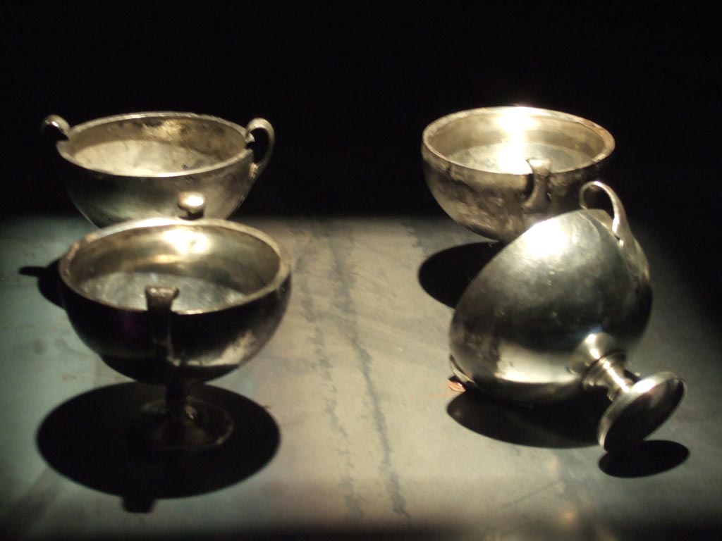 Four silver kantharos or cups found 20th September 1887 in VIII.2.23.
Now in Naples Archaeological Museum. Inventory numbers 116329, 116330, 116331 and 116332.
See Guzzo, P. (A cura di), 2006. Argenti a Pompei. Milano, Electa. (pp. 130-4).