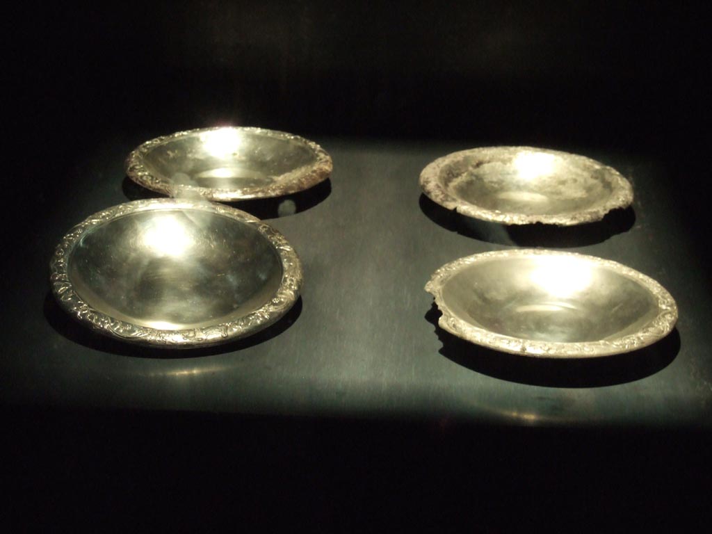 Four silver plates found 20th September 1887 in VIII.2.23.
Now in Naples Archaeological Museum. Inventory numbers 116345, 116346, 116347 and 116348.
See Guzzo, P. (A cura di), 2006. Argenti a Pompei. Milano, Electa. (pp. 130-4).