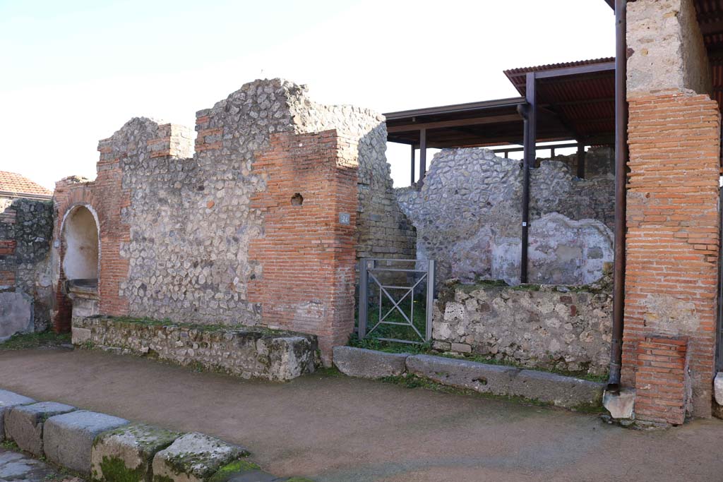 VIII.2.24, Pompeii, on right, with altar at VIII.2.25, on left. December 2018.
Looking towards entrances on south side of Via della Regina. Photo courtesy of Aude Durand.
