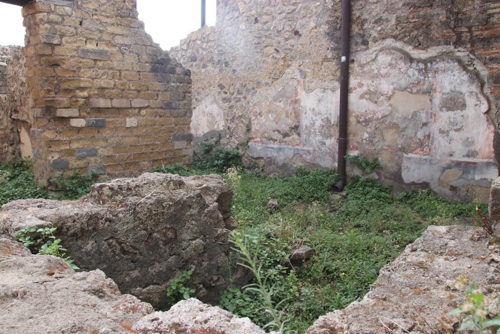 VIII.2.24 Pompeii. October 2023.
Looking south-east across bar-room, with doorway into the kitchen with hearth and latrine, on left. Photo courtesy of Klaus Heese.