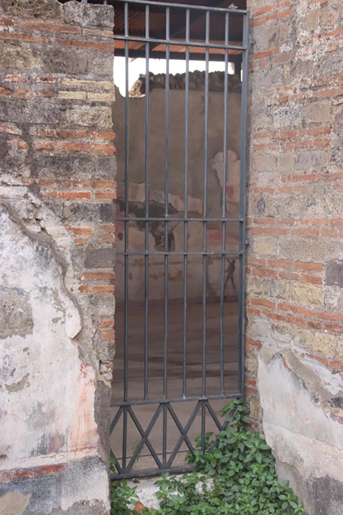 VIII.2.24 Pompeii. October 2023.
Doorway into Palestra in south-west corner of bar-room. Photo courtesy of Klaus Heese.