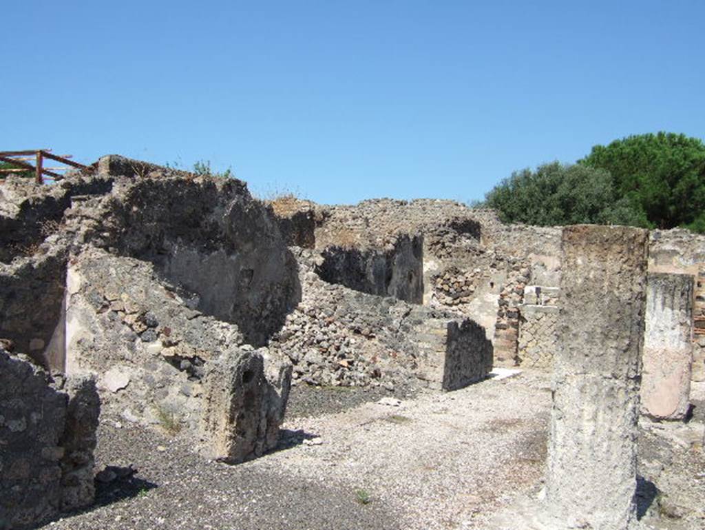 VIII.2.28 Pompeii. September 2005. Rooms on west side of atrium. According to Richardson, the rooms on the west side of the atrium were much shallower than those on the east.
The small rooms on either side of the central ala may have been storerooms.
See Richardson, L., 1988. Pompeii: an Architectural History. Baltimore: John Hopkins University Press. (p.231-2).
In the north-west corner of the atrium is a masonry base, just visible to the left of the column. This was the lararium. The top of it had three small steps of marble (see below).
The aedicula that was originally on the base has disappeared. On the north wall above the base, when excavated, the figures of the Lares could still be seen.
See Boyce G. K., 1937. Corpus of the Lararia of Pompeii. Rome: MAAR 14. (p74, no.345)