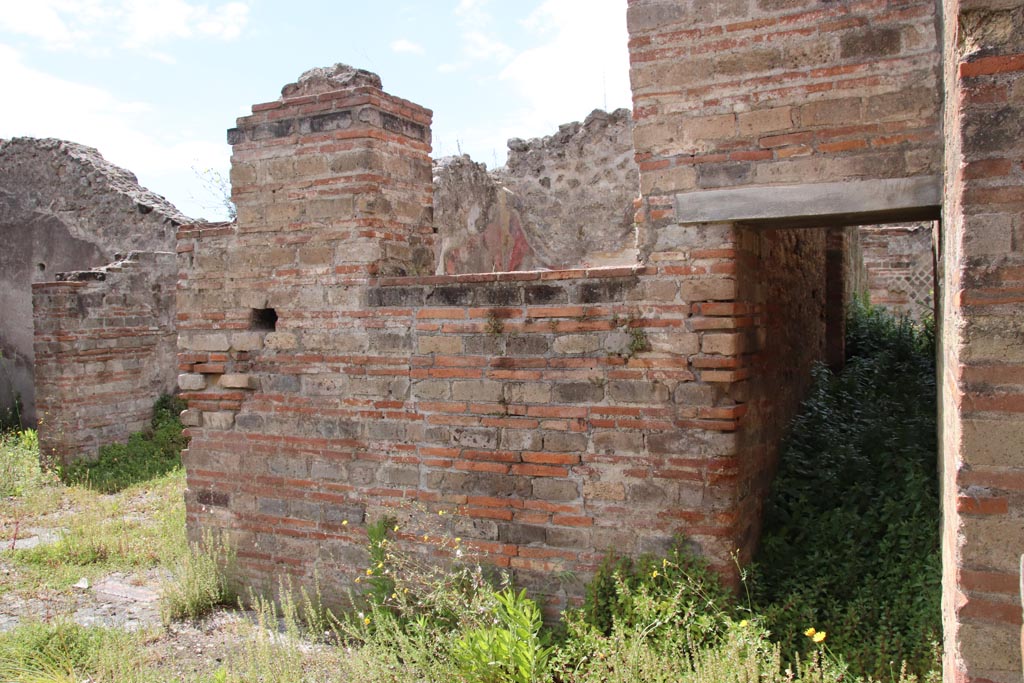 VIII.2.30 Pompeii. May 2024.
North-west corner of atrium, with doorway to cubiculum, on left, on south side of open recess with steps into VIII.2.29.
On the right can be seen the doorway to the corridor in the west wall of the atrium. Photo courtesy of Klaus Heese.