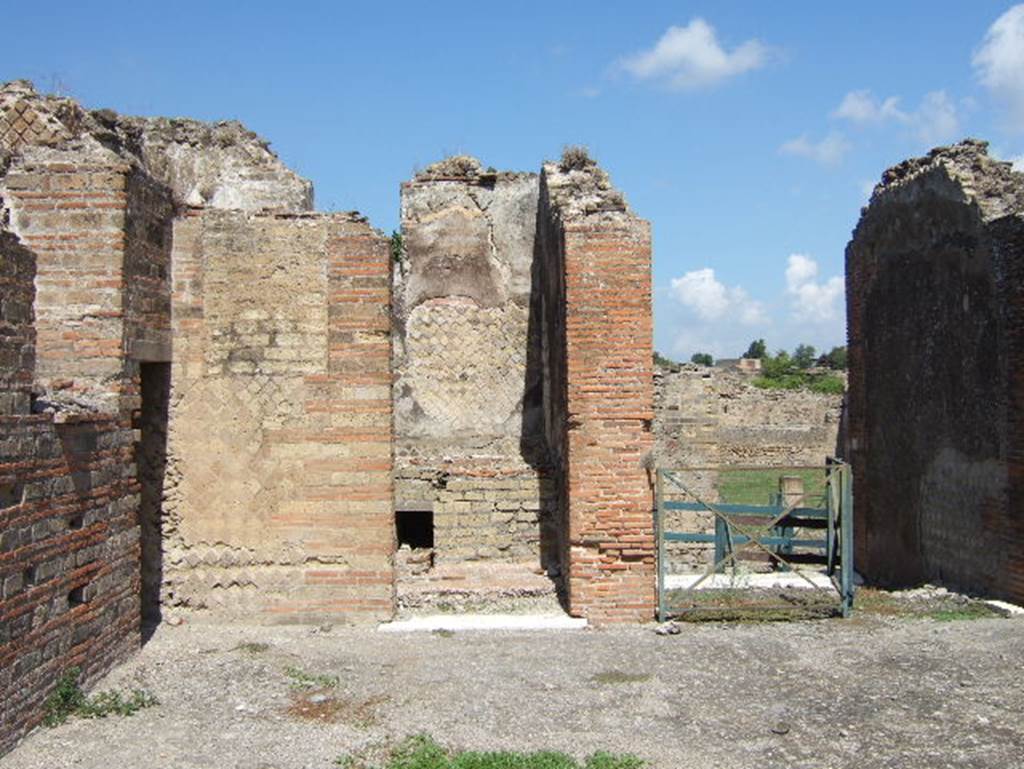 VIII.2.30 Pompeii. September 2005. Looking north in north-west corner of atrium, into doorway of kitchen, centre left.
On the right is the entrance doorway from Vicolo della Regina.