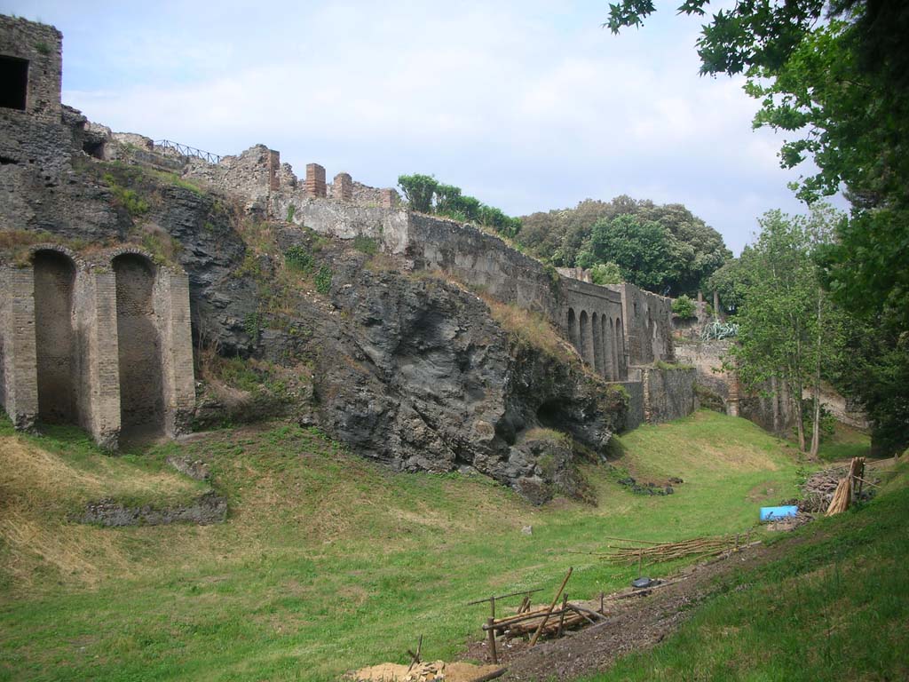 Rear of VIII.2.28, on left, and VIII.2.30 with city wall built on top of volcanic ledge, in centre. May 2011.
Looking east along rear of “hanging houses”. Photo courtesy of Ivo van der Graaff.