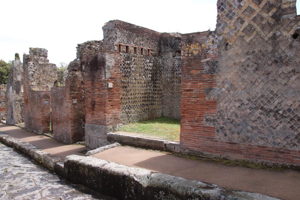 VIII.2.31 Pompeii. May 2024.
Looking east along south side of Via della Regina towards entrance doorway. Photo courtesy of Klaus Heese.