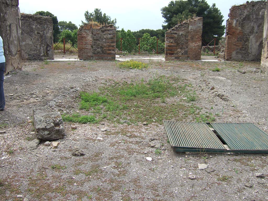 VIII.2.34 Pompeii. May 2006. Looking south across remains of impluvium in atrium, ‘c’.
According to NdS, the atrium was rather spacious and in the middle was a large impluvium.
The impluvium was found without any of the marble that at one time it would have been covered with.
Around its edge would have been a beautiful “greca” black and white mosaic.
The floor was of black mosaic scattered with small mosaics of white cubes and white small stars.
The walls of the atrium, like those of the entrance corridor, did not have any decoration just being clad in rustic plaster.
At the sides of the impluvium were two cistern-mouths, one in the northern edge and the other in the southern.
See Notizie degli Scavi, April 1885, (p.163)