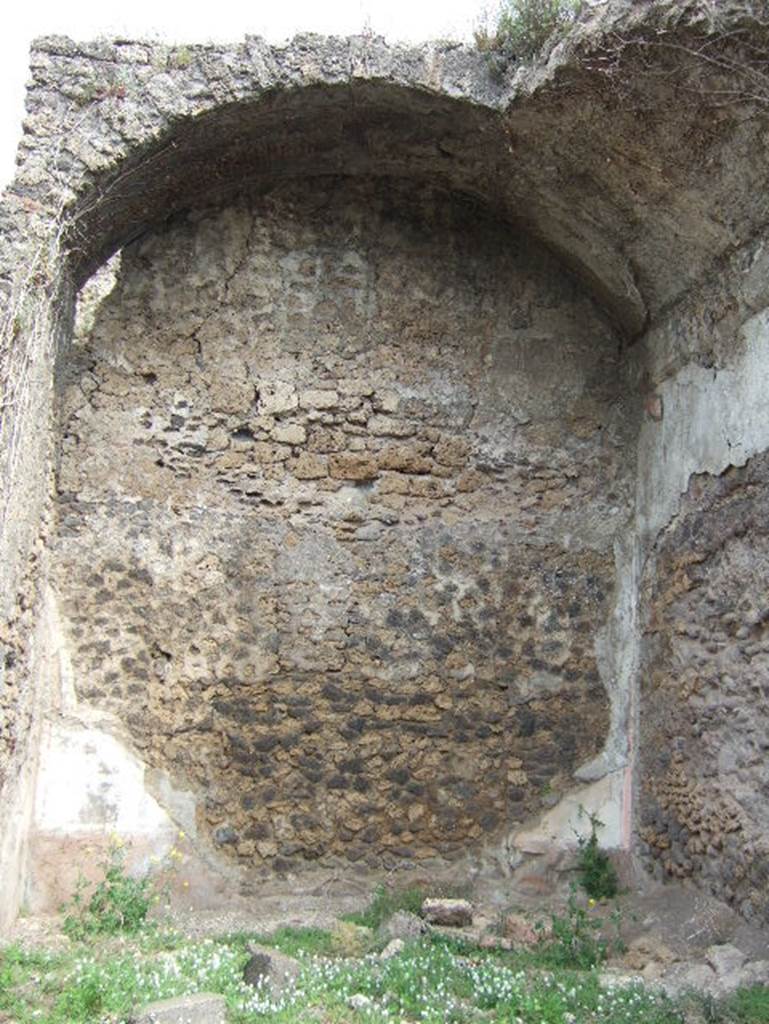 VIII.2.34 Pompeii. May 2006. Room ‘10’, north wall of triclinium on east side of lower level.
Originally the flooring would have been a black mosaic with rows of crosses of small tesserae with a white border, similar to the atrium ‘c’. Nothing of this can be seen now, and the only remains of painted wall plaster can be seen on the north wall, protected by the vaulted ceiling. The zoccolo was black, and like the middle zone was crossed in panels with candelabra; red on the upper part, a red band protruding crowned at the top with a stucco cornice.