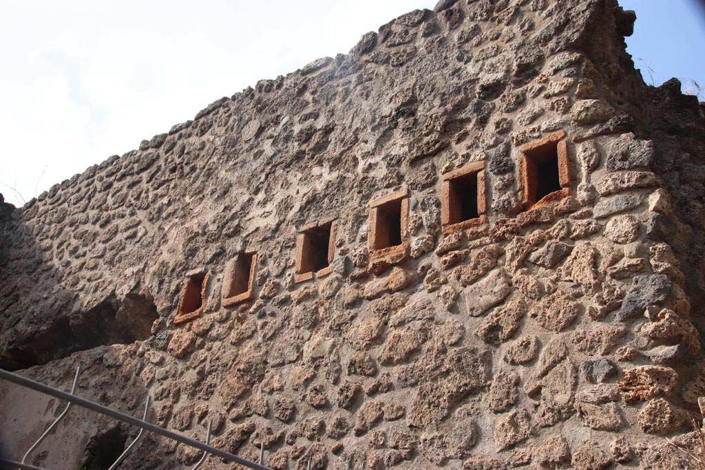 VIII.2.38 Pompeii. October 2023.
West wall of shop-room, with holes for support beams for an upper floor. Photo courtesy of Klaus Heese.