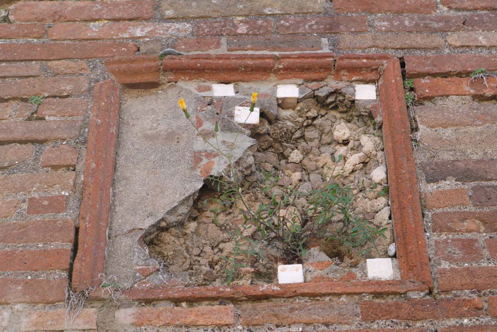 VIII.3.6 Pompeii, on left, and VIII.3.5, on right. December 2018.
Detail of plaque on pilaster between doorways. Photo courtesy of Aude Durand.