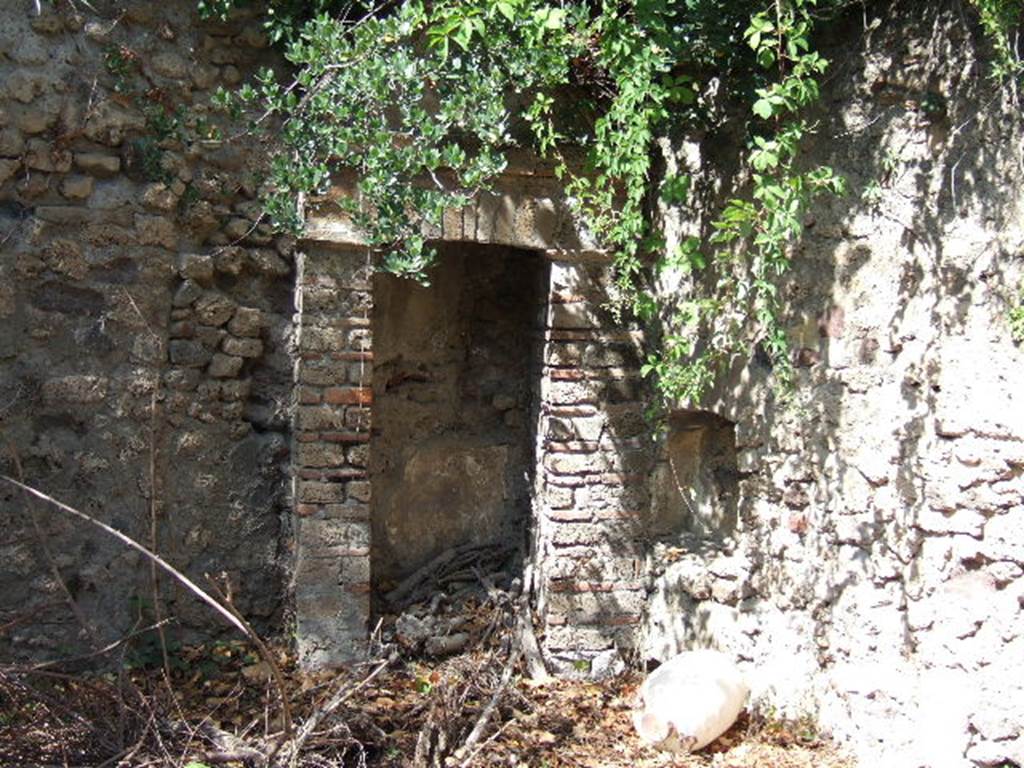 VIII.3.14 Pompeii. September 2005. North-west corner of garden.
According to Boyce, in the north-west corner of the garden was a niche adorned with an aedicula facade. There were two rectangular pilasters supporting a pediment, and built on the top of a base. Before the aedicula stood an altar.
See Boyce G. K., 1937. Corpus of the Lararia of Pompeii. Rome: MAAR 14. (p.75, no.351).