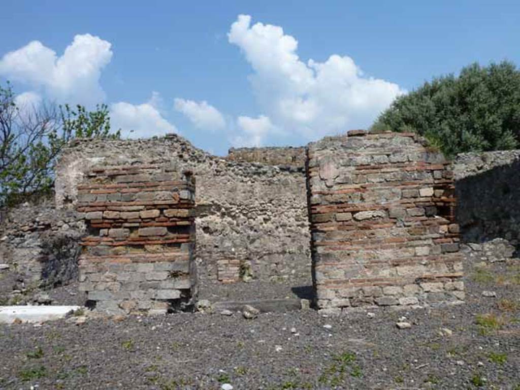 VIII.3.15 Pompeii. May 2010. Looking north towards doorways to south portico 8 of garden area, from entrance.
The two square pillars supported the portico on the south side of the garden and were painted with vines, according to Jashemski.
See Jashemski, W. F., 1993. The Gardens of Pompeii, Volume II: Appendices. New York: Caratzas, (p. 211).
The left pilaster would have separated the walls of rooms 2 and 1, the right pilaster would have separated rooms 1 and 9.