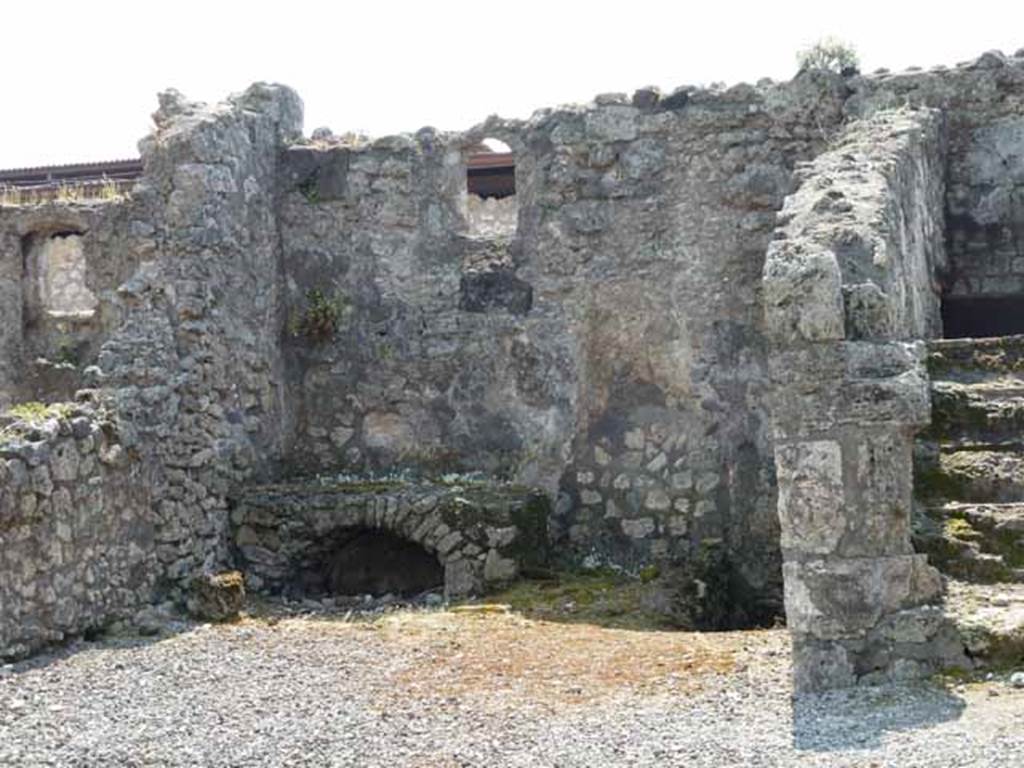 VIII.3.18 Pompeii. May 2010. Looking south towards right ala, being used as a kitchen with hearth. Taken from VIII.3.19. A niche latrine can be seen on the west (right side) of the hearth.
See Hobson, B., 2009. Pompeii, Latrines and Down Pipes. Hadrian Books (p.440 and photo p.444)
According to Boyce, Helbig saw a fragmentary lararium painting with the figure of the Lares, in the kitchen. (Helbig 91).
See Boyce G. K., 1937. Corpus of the Lararia of Pompeii. Rome: MAAR 14. (p.76, no.355) See Helbig, W., 1868. Wandgemälde der vom Vesuv verschütteten Städte Campaniens. Leipzig: Breitkopf und Härtel. (no.91)