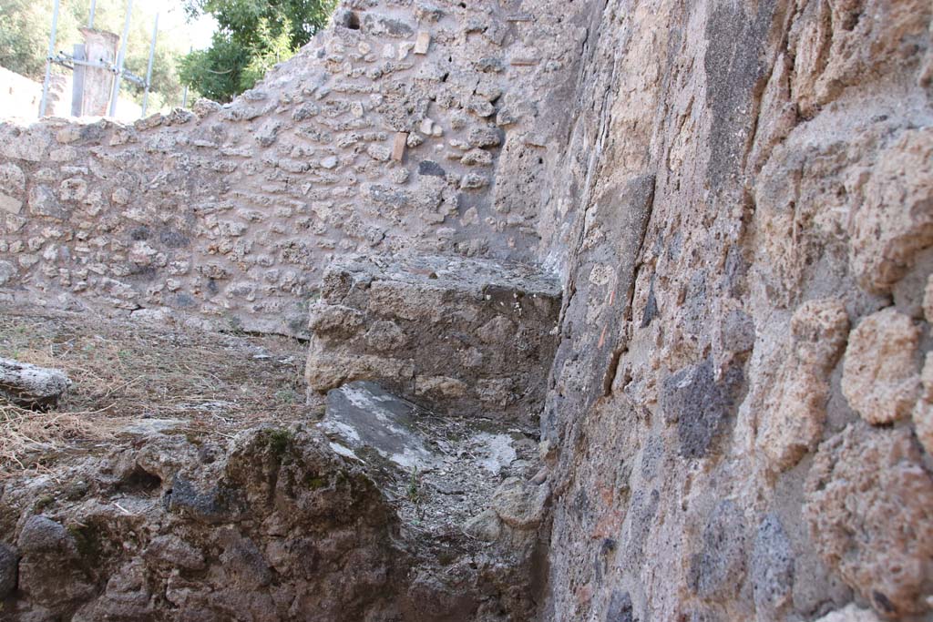 VIII.3.18 Pompeii. September 2021.
Looking towards east wall in south-east corner of kitchen, and east side of hearth. Photo courtesy of Klaus Heese.