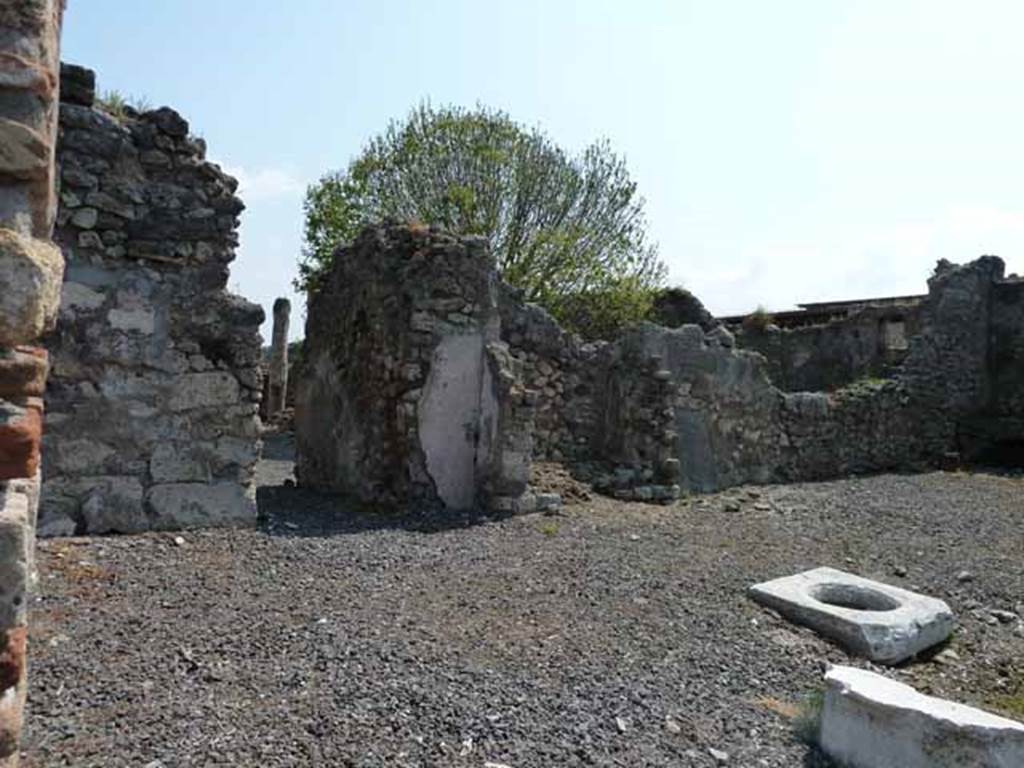 VIII.3.18 Pompeii. May 2010. Looking east across atrium towards corridor to rear rooms and peristyle. Taken from VIII.3.19. According to Boyce, there is a large recess formed from heavy masonry walls (in the centre of the photo). Fiorelli called it simply a recess to contain a cupboard, but Breton thought it was the lararium. According to Boyce, it may well have been a lararium.