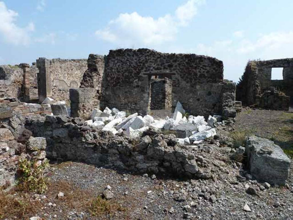 VIII.3.31 Pompeii. May 2010. Looking east across small room or cupboard in the north-west corner of the portico, towards the oecus with two doorways. Taken across the wall of VIII.3.29.
