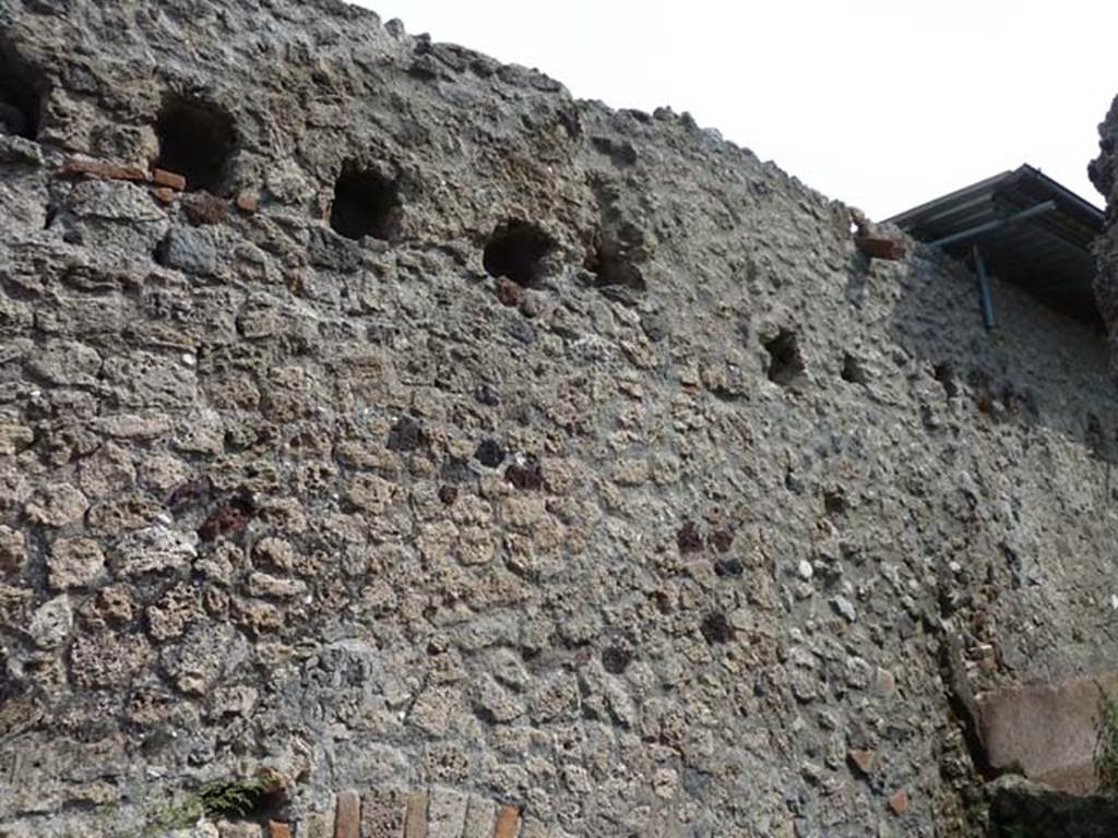 VIII.4.1 Pompeii. September 2015. Holes for support beams for upper floor in east wall in workshop area.
