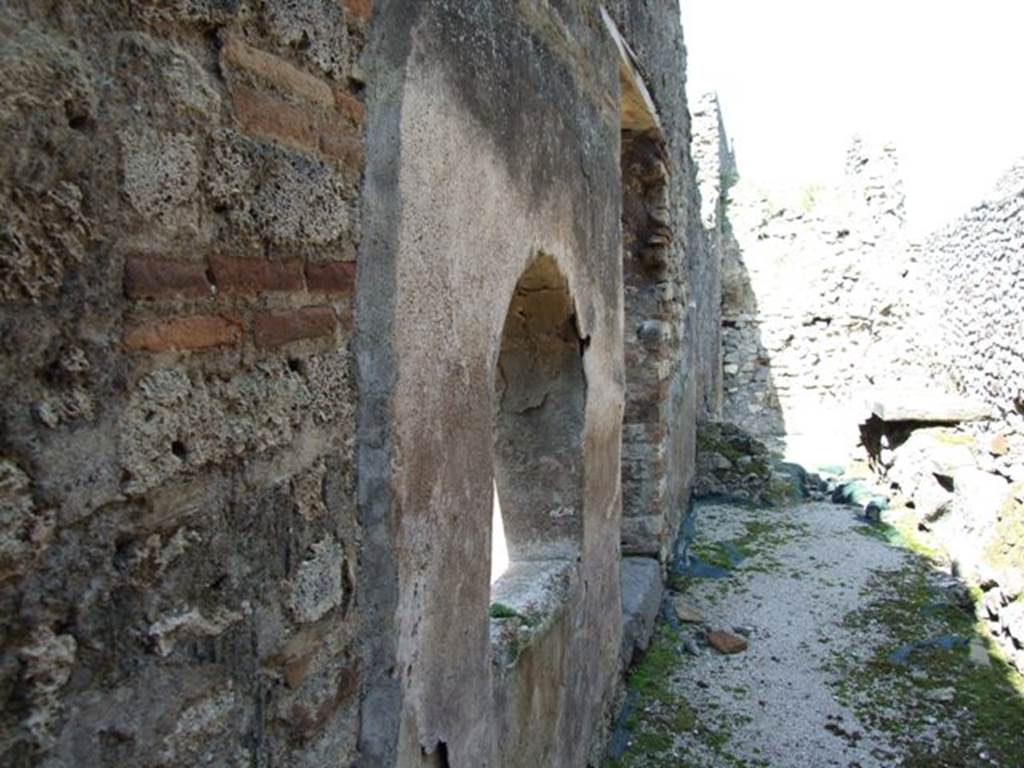 VIII.4.4 Pompeii. March 2009. Room 7. Kitchen. West wall with arched opening, connecting the kitchen to the basin in area 8.