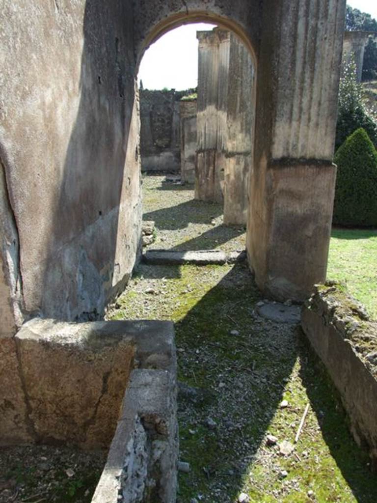 VIII.4.4 Pompeii. March 2009. Room 8. Corridor on west side of kitchen, with basin. Looking south to east portico.