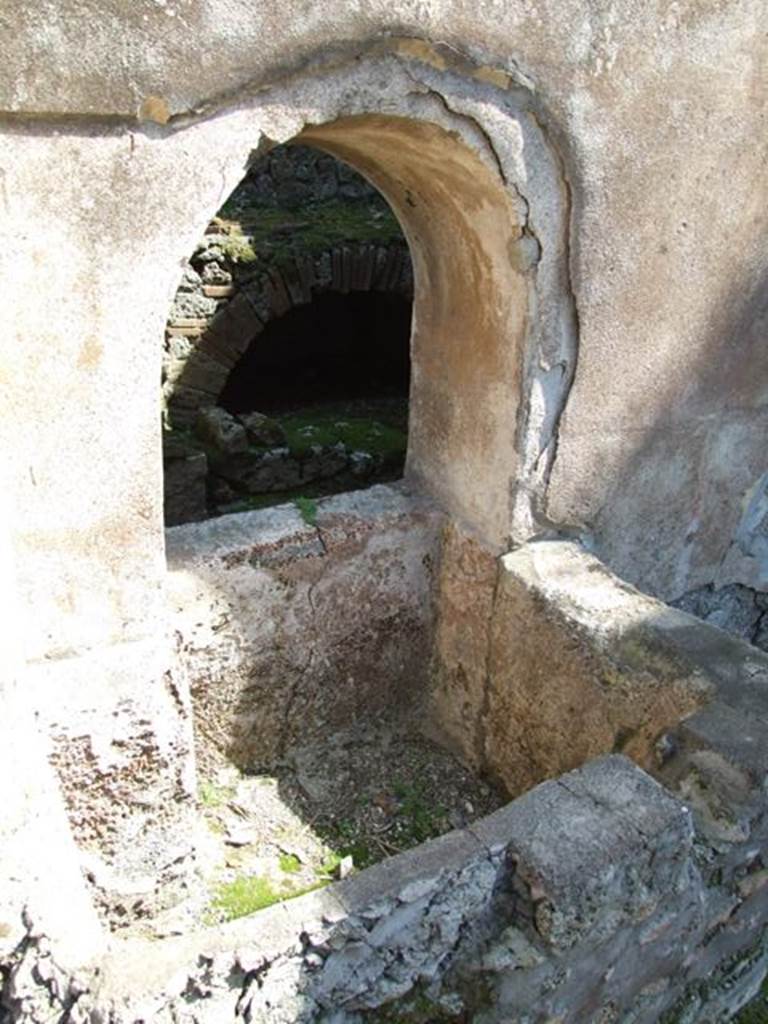 VIII.4.4 Pompeii. March 2009. Room 8. Corridor on west side of kitchen, with square basin, beneath arched opening.