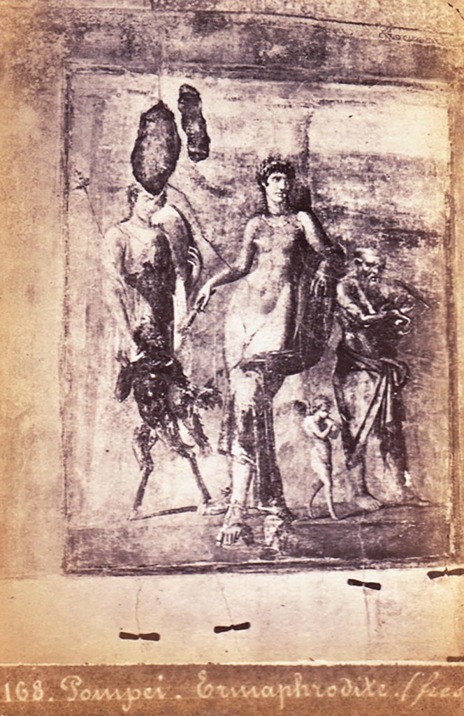 VIII.4.4 Pompeii.
Room 11, east wall of exedra, detail of painting in exedra at rear of peristyle.
On the left - a standing Dionysian maenad, and a small Pan
In the centre - the Hermaphrodite
On the right - Amor and Papasilenos.
Photo courtesy of Espen B. Andersson.