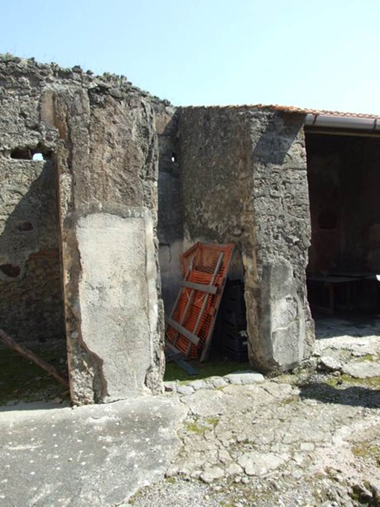 VIII.4.4 Pompeii. March 2009. Doorway to room 3.
According to PPM, the floor in this room was of lavapesto, whereas the atrium floor can be seen to include small tesserae of small white dots.
On the east side of the south wall of room 3, a medallion containing a griffin could be seen in the side panel, but hardly a trace is now left.
This room also had a Dionysian theme, similar to room 22, in that in the central panel of the white middle zone of the wall was a painting of a maenad and a satyr.
On the west side of the south wall, with a faded zoccolo and a white middle zone, was a panel crossed by a candelabra and medallion containing a griffin.
According to Fiorelli, “the threshold of the room was formed of Vesuvian stone, and the floor was of opus signinum with small pieces of marble encrusted into it for decoration.
The zoccolo of the walls were red and showed painted green plants, the middle zone was white divided into panels by small green lines and yellow ornaments:
there were branches with leaves, and yellow candelabra topped with ornate globes, nearly similar to those from the cubiculum facing across the atrium.” (See room 22).
See Pompei: Pitture e Mosaici, Vol. VIII parte 1, pp. 451ff.
