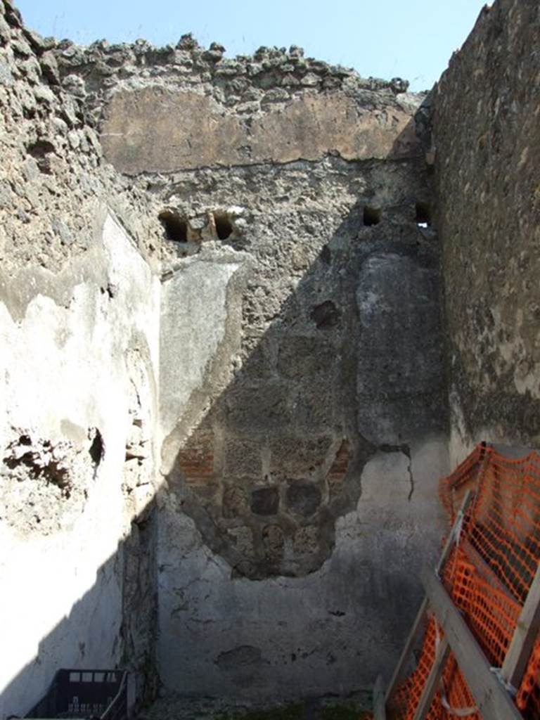 VIII.4.4 Pompeii. March 2009. Room 3, looking east. According to PPM in the north-east corner were the remains of a moulded stucco cornice. The holes for the supports of the floor joists of the room above could be seen. A large hole, filled by the restorers, was left as a sign of ancient searchers in the room. The decorative scheme from the short wall is completely lost. The zoccolo was red, in a side panel of the middle zone was a painting showing the head of Silenus.
See Helbig, W., 1868. Wandgemälde der vom Vesuv verschütteten Städte Campaniens. Leipzig: Breitkopf und Härtel, (413). See Pompei: Pitture e Mosaici, Vol. VIII parte 1, Roma: Istituto della enciclopedia italiana, pp. 451ff.