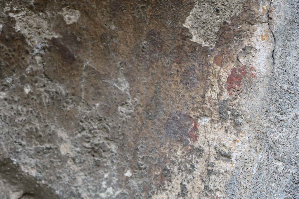 VIII.4.12, Pompeii. December 2018.
Detail of remaining plaster in niche, red and yellow flowers, perhaps. Photo courtesy of Aude Durand.