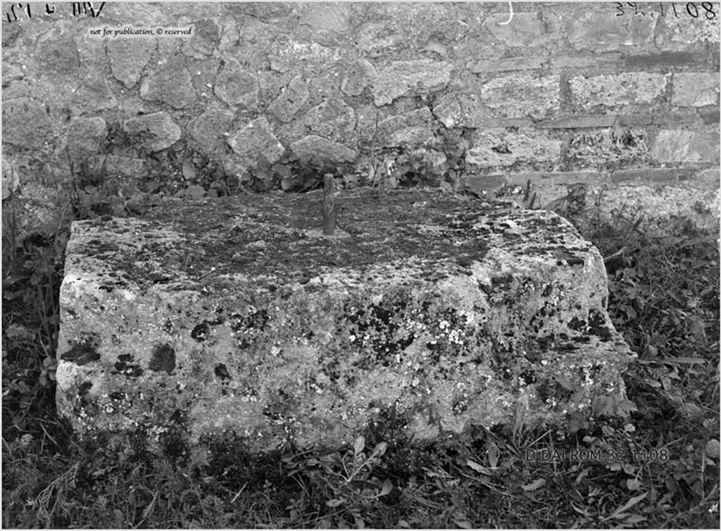 VIII.4.12 Pompeii. 1932. Large stone used as base for an arca, near south wall of peristyle.
According to Pernice –
The base was found on the south side of the peristyle between 2 rooms in front of a late period wall with brick surround.
The base is irregularly notched at the corners. In the middle there is a fastening pin in the lead cast.
See Pernice, E., 1932. Hellenistische Tische, Zisternenmündungen, Beckenuntersätze, Altäre u. Truhen. Berlin, p. 73, Taf. 43.6.
DAIR 32.1108. Photo © Deutsches Archäologisches Institut, Abteilung Rom, Arkiv.
Thanks to Espen B. Andersson for assisting us in our interest in money-chests.