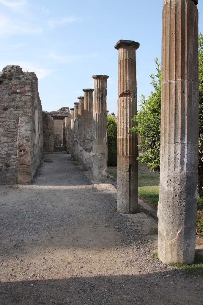VIII.4.15 Pompeii. September 2021.
Looking north along west portico, with doorway to exedra 17, on left. Photo courtesy of Klaus Heese.