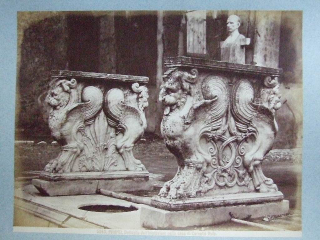 VIII.4.15 Pompeii. Supports of marble table or cartibulum. Bust and herm of C Cornelio Rufo – are in background. Undated photograph. Courtesy of Society of Antiquaries. Fox Collection.