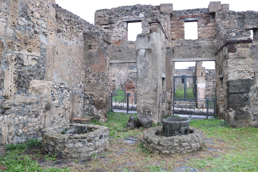 VIII.4.26 Pompeii, on left, and VIII.4.27, on right. December 2018.
Looking east across bakery towards entrance doorways onto Via Stabiana. Photo courtesy of Aude Durand.