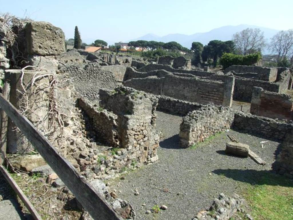 VIII.4.27 Pompeii. March 2009. Looking south-east from south portico of VIII.4.15, onto lower level and the rear rooms, looking onto the east portico and garden area.