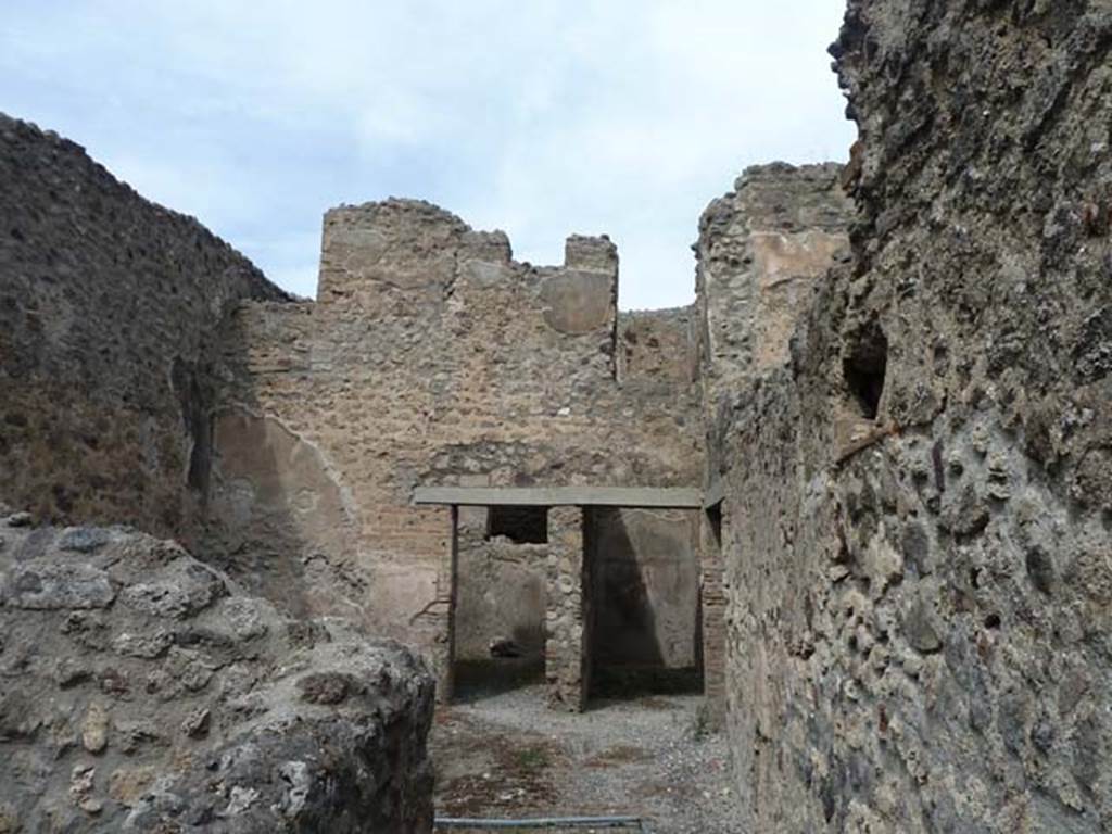 VIII.4.37 Pompeii. September 2015. Looking north from entrance corridor into central courtyard with two doorways in its north wall, and doorway to corridor in the east wall, on right. According to Eschebach, this room was either a small cavaedium (central courtyard) or a sitting room.
See Eschebach, L., 1993. Gebäudeverzeichnis und Stadtplan der antiken Stadt Pompeji. Köln: Böhlau. (p.376-7)