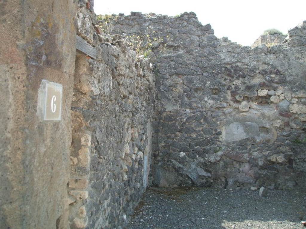 VIII.5.6 Pompeii. May 2005. East wall with communicating doorway to VIII.5.7, and south wall. According to Hobson, a wall scar of a down-pipe can be seen in the south-east corner of the shop. See Hobson, B., 2009. Pompeii, Latrines and Down Pipes. Oxford, Hadrian Books. (p.460).