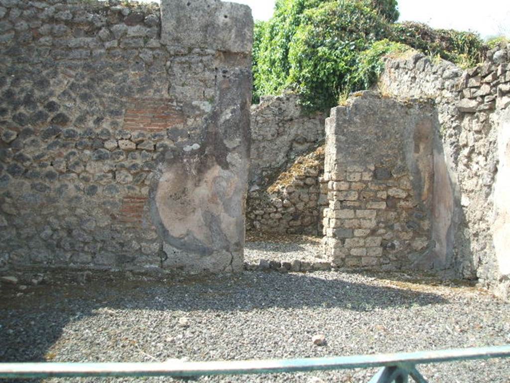 VIII.5.8 Pompeii. Shop. May 2005. South wall with door to room containing stairs to upper floor.