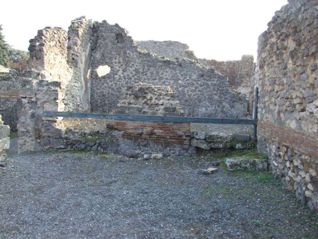 VIII.5.11 Pompeii. Shop. December 2007. Shop in foreground, with step and doorway to VIII.5.9 at rear.