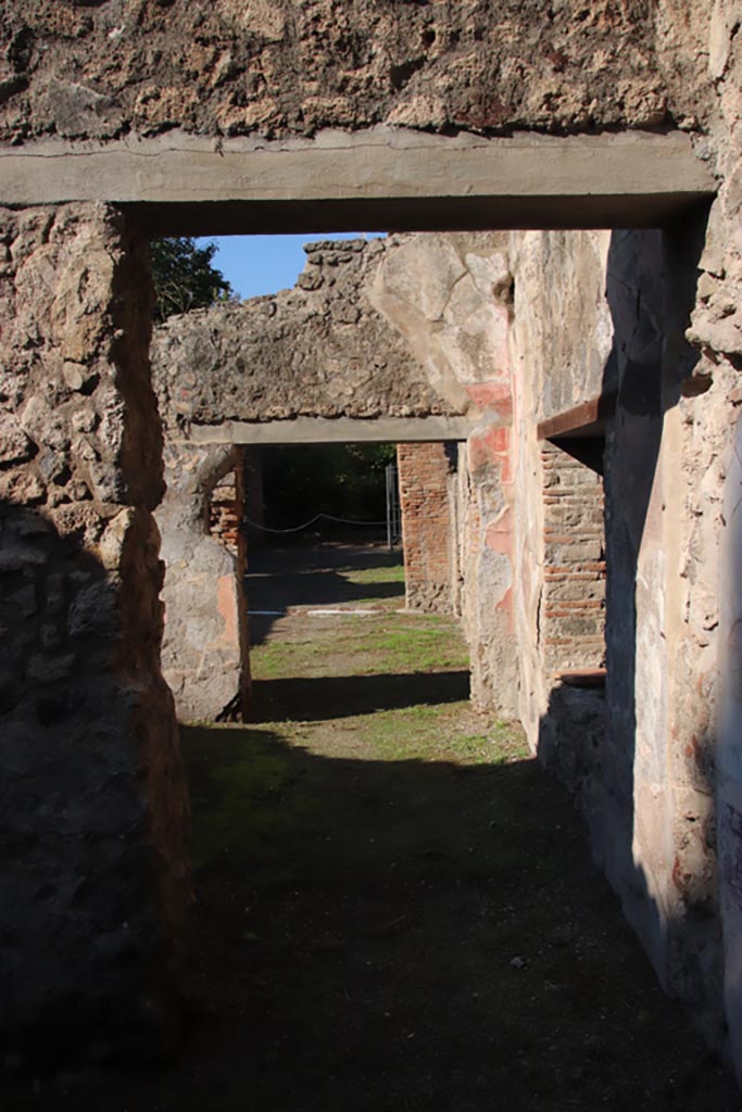 VIII.5.16 Pompeii. October 2022.
Doorway in west wall of room 7, looking across room 6, into room 5, and onto north portico.
Photo courtesy of Klaus Heese.