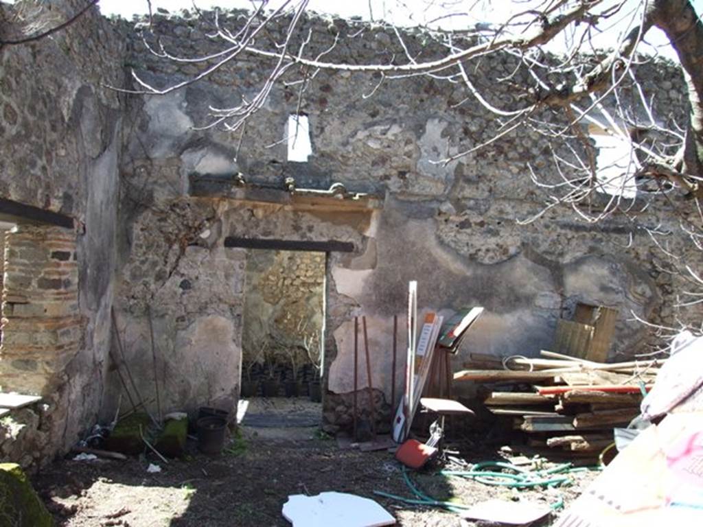 VIII.5.16 Pompeii. March 2009.
Room 11, small garden area, looking west to south-west corner, and west wall with doorway into room 9.