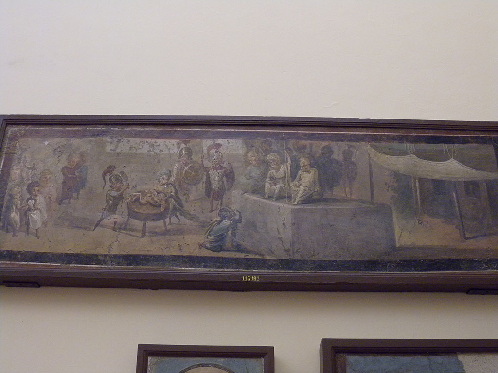 VIII.5.24 Pompeii. Detail from wall painting of Pygmies acting the Judgement of Solomon.
From a low wall connecting peristyle columns in VIII.5.24.
Now in Naples Archaeological Museum. Inventory number 113197.