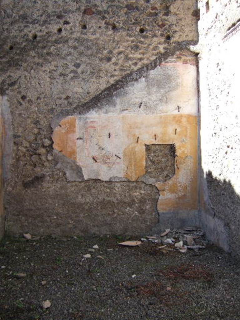 VIII.5.39 Pompeii. September 2005. Room 5, west wall.
According to PPM � The IV Style decoration is better preserved on this wall.
The central panel was white, the side panels were yellow edged with a border of �carpet� design; 
the one on the right (north end) contained a medallion showing the head of a young girl � now taken off
The zoccolo would have been black with painted plants.
See Carratelli, G. P., 1990-2003. Pompei: Pitture e Mosaici: Vol. VIII. Roma: Istituto della enciclopedia italiana, p. 659.
