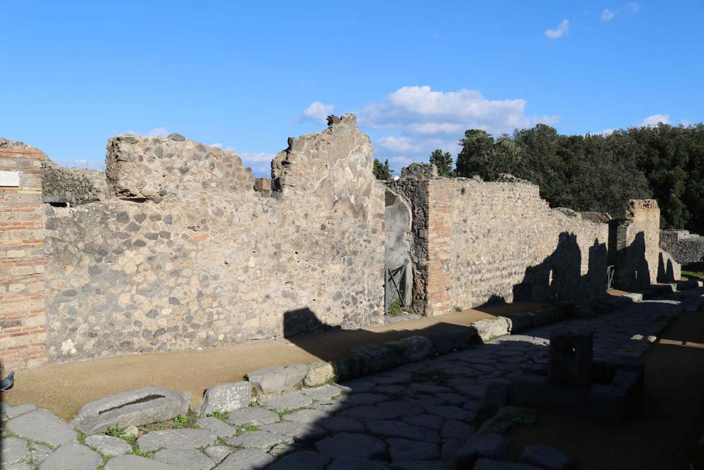 VIII.6.1, Pompeii. December 2018. Entrance doorway, in centre, on north side of Via della Regina. Photo courtesy of Aude Durand.