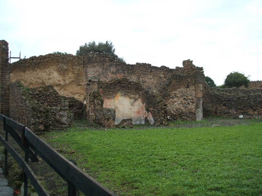 VIII.6.3 Pompeii. December 2004. Looking west. According to Boyce, on the west wall of a room which was perhaps a kitchen, was a partially preserved lararium painting. In the upper zone, the feet of the Genius, to the right of him, a Lar in red and blue tunic, again to the right a long staff, perhaps with sausages attached to it. Below the figure of the Genius, a tile was embedded in the wall to hold offerings. Below this, was a serpent (black with a yellow belly, red crest and beard) advancing towards a second serpent (smaller and all black with crest). This second serpent was coiled around a black omphalos covered with a green net and standing upon a rectangular base. See Boyce G. K., 1937. Corpus of the Lararia of Pompeii. Rome: MAAR 14. (p.78, no.373)
According to Giacobello, the picture on the west wall of kitchen has not been conserved. The small service area was located in the south-west corner of the house. See Giacobello, F., 2008. Larari Pompeiani: Iconografia e culto dei Lari in ambito domestico. Milano: LED Edizioni. (p.204)