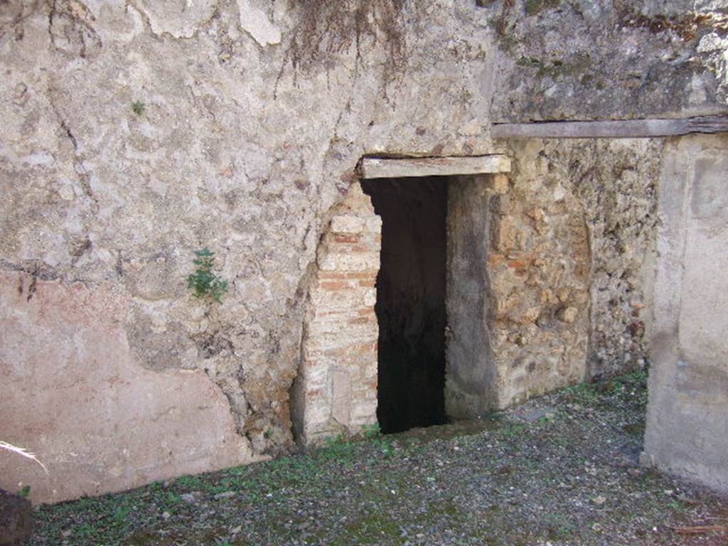 VIII.6.9 Pompeii. September 2005. Looking south-west towards doorway to basement room/water tank under VIII.6.10. The wall on the right, described by Mau as a thin wall, would have supported the dividing wall between rooms “r” and “s” on the ground floor level.
See BdI, 1884, p.186, and plan below.