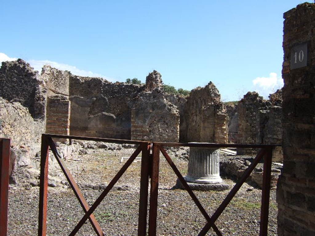VIII.6.10 Pompeii. September 2005. Looking east from entrance into area of peristyle.
According to Mau, the dwelling of the owner of the bakery was placed around the peristyle.
It had a separate entrance doorway from the western roadway, preceded by a step covered with roof tiles, one of which had a stamp mark. See BdI, 1884, p.182.
According to Jashemski, the area was not a garden but had a pavement of opus signinum.
The area was enclosed on all four sides by a portico, supported by three columns on the north and south. The columns were painted black below, and red above. Today, only the bases of the columns remain. In the middle of the paved area, according to the reports, there was a rectangle lined with pieces of white and grey marble, in which pieces of yellow marble formed a cross. In the centre of the cross was a little yellow square bordered by a narrow red stripe. Today it is much damaged. The various rooms of the house opened off the portico, which could be entered directly from the street at VIII.6.9. The atrium at the front of the house had been converted into a bakery, VIII.6.1.
See Jashemski, W. F., 1993. The Gardens of Pompeii, Volume II: Appendices. New York: Caratzas. (p.219)