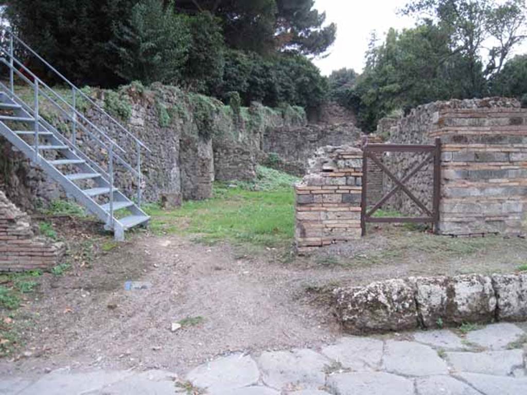 VIII.7.1 Pompeii. September 2010. Entrance on Via Stabiana, looking west (across street). VIII.7.1 entrance is left of the square gate. Photo courtesy of Drew Baker.